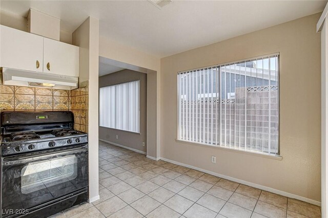 kitchen featuring white cabinetry, gas stove, tasteful backsplash, and light tile patterned floors