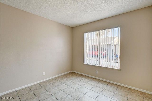 unfurnished room featuring light tile patterned floors and a textured ceiling