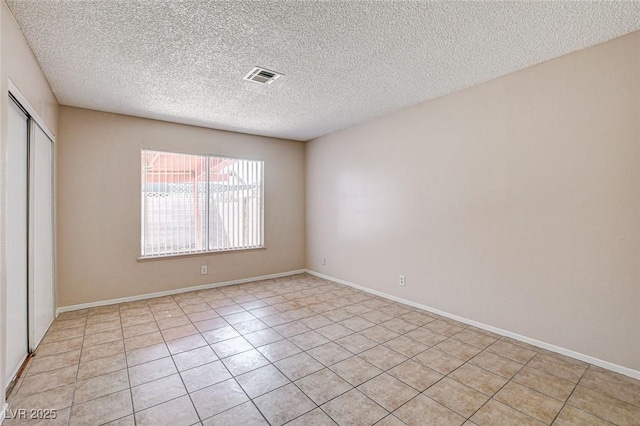 unfurnished room featuring a textured ceiling