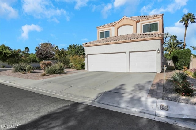 mediterranean / spanish-style house with a garage