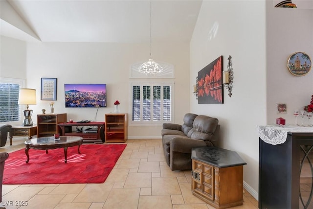 living room with a notable chandelier and high vaulted ceiling