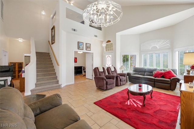 living room with an inviting chandelier and a towering ceiling