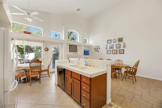 kitchen with plenty of natural light, dishwasher, sink, and white fridge with ice dispenser