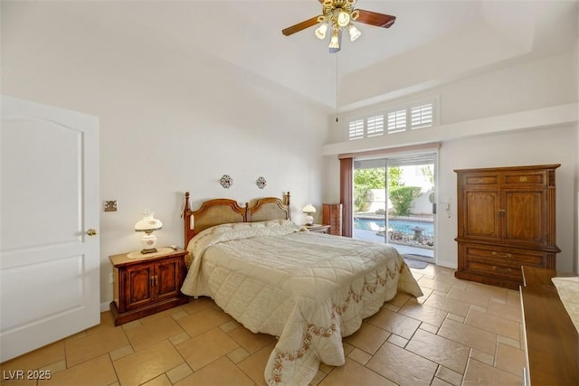 bedroom with ceiling fan, access to exterior, and a high ceiling