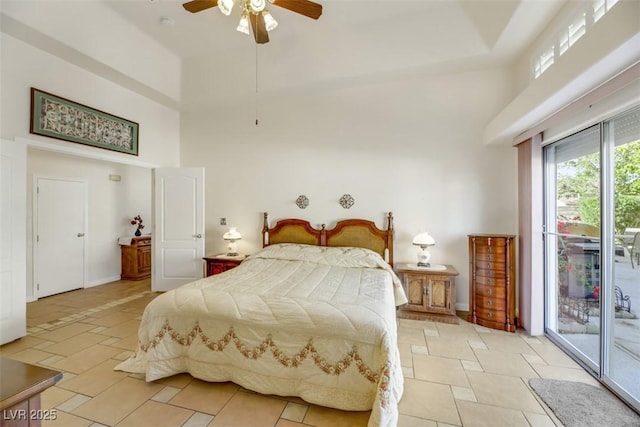 bedroom featuring ceiling fan, access to exterior, and a high ceiling