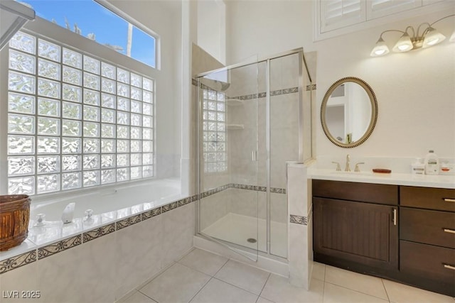 bathroom with tile patterned flooring, vanity, and plenty of natural light