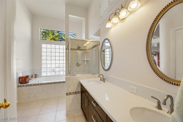 bathroom with tile patterned flooring, plus walk in shower, and vanity