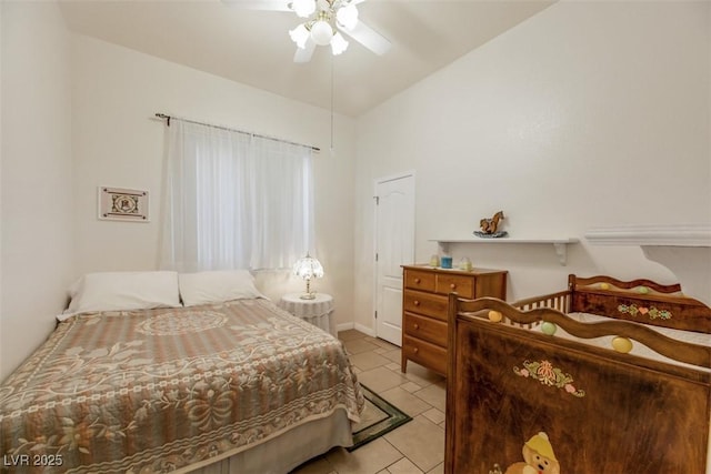 bedroom with ceiling fan, vaulted ceiling, and light tile patterned floors