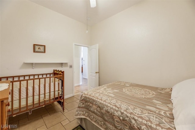 bedroom featuring ceiling fan, high vaulted ceiling, and light tile patterned floors