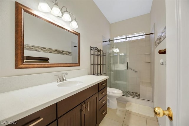 bathroom featuring tile patterned floors, vanity, toilet, and an enclosed shower