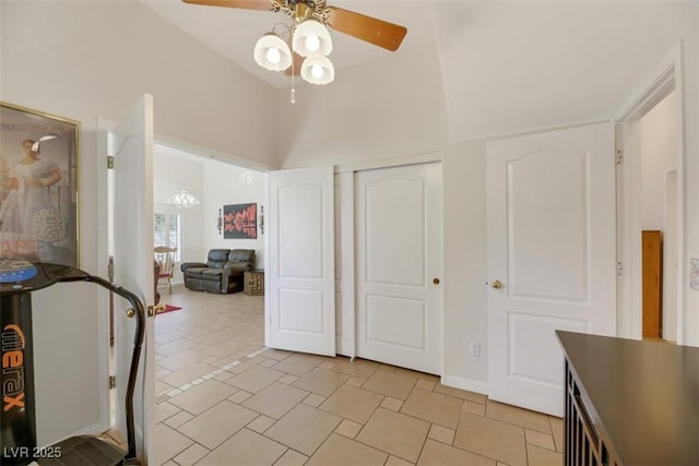 interior space with ceiling fan, high vaulted ceiling, and a closet