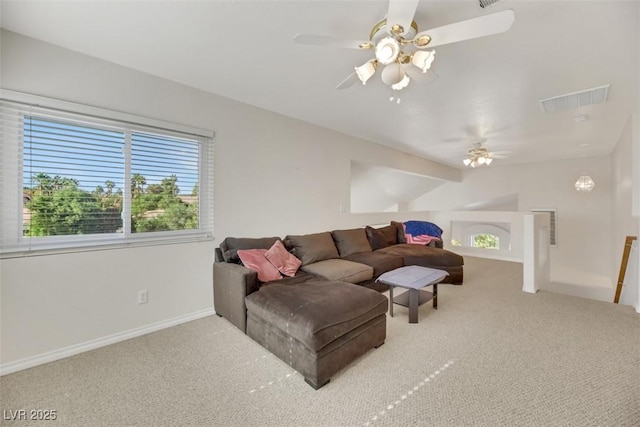 carpeted living room with ceiling fan and lofted ceiling