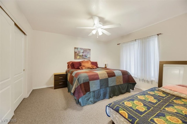 carpeted bedroom with ceiling fan and a closet