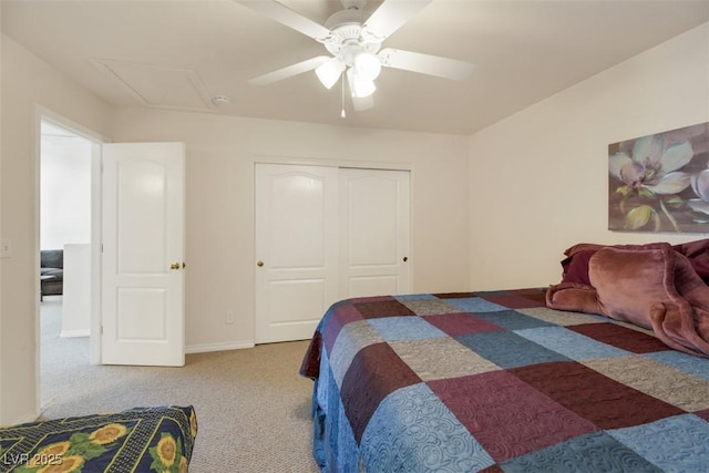 bedroom with ceiling fan, light colored carpet, and a closet