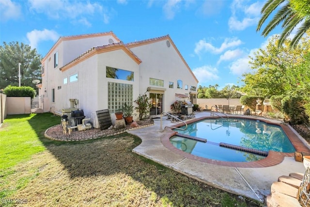 view of swimming pool with a patio area and a lawn