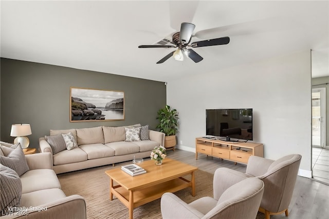 living room with hardwood / wood-style floors and ceiling fan