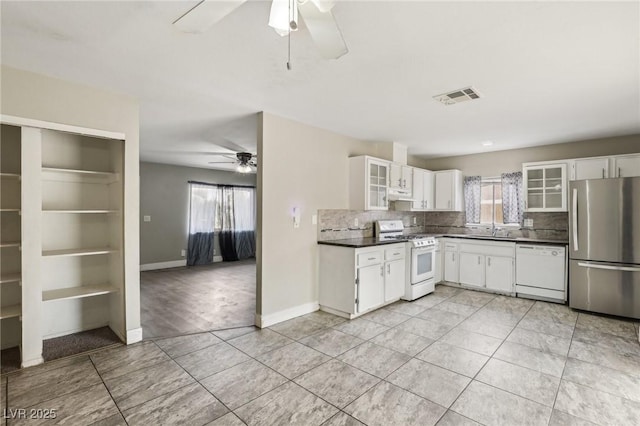 kitchen with sink, white appliances, ceiling fan, white cabinetry, and backsplash