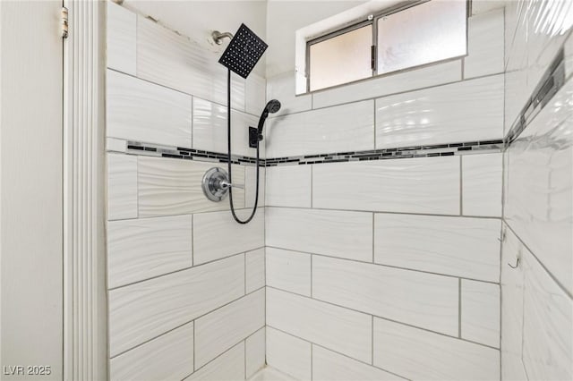 interior details featuring tiled shower