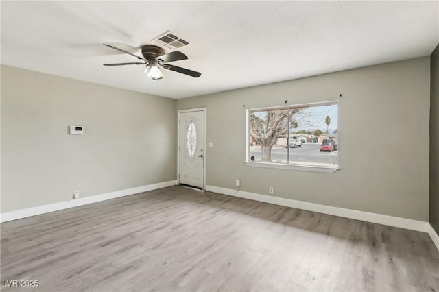 foyer entrance with ceiling fan and light wood-type flooring