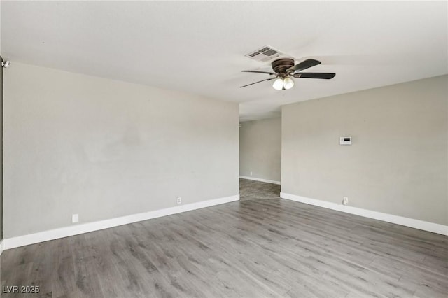 spare room with hardwood / wood-style floors and ceiling fan