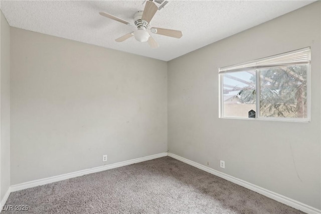 carpeted empty room with ceiling fan and a textured ceiling