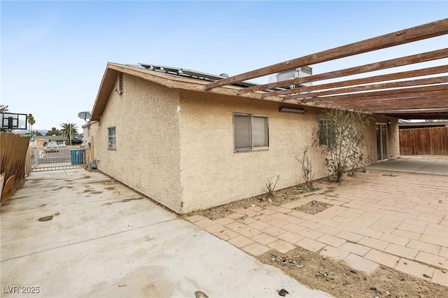 view of side of home with a patio