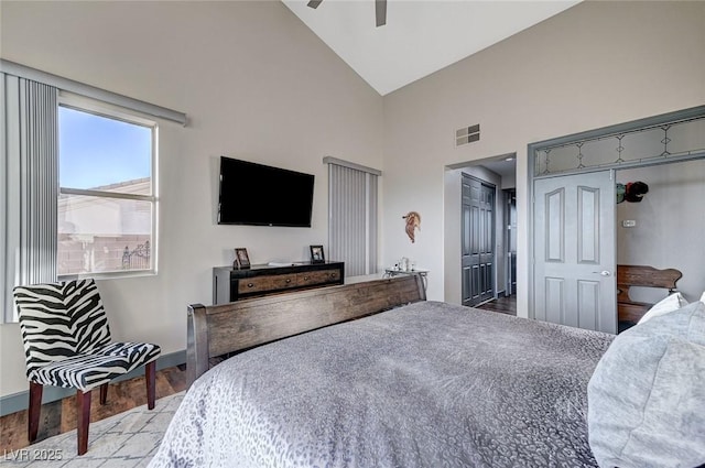 bedroom featuring ceiling fan, high vaulted ceiling, and light wood-type flooring