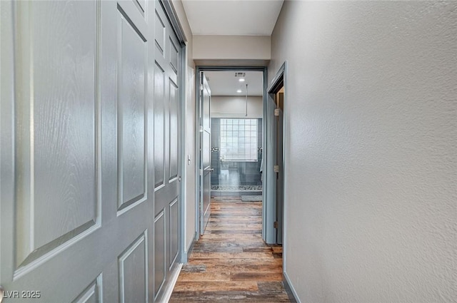 hallway with dark wood-type flooring