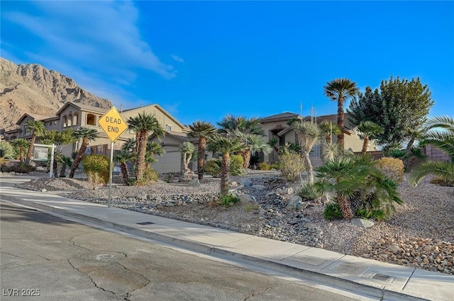 view of front of property featuring a garage and a mountain view