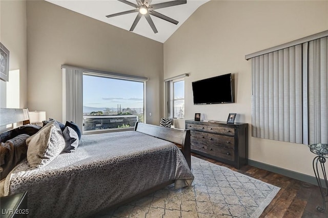 bedroom with dark hardwood / wood-style flooring, high vaulted ceiling, and ceiling fan