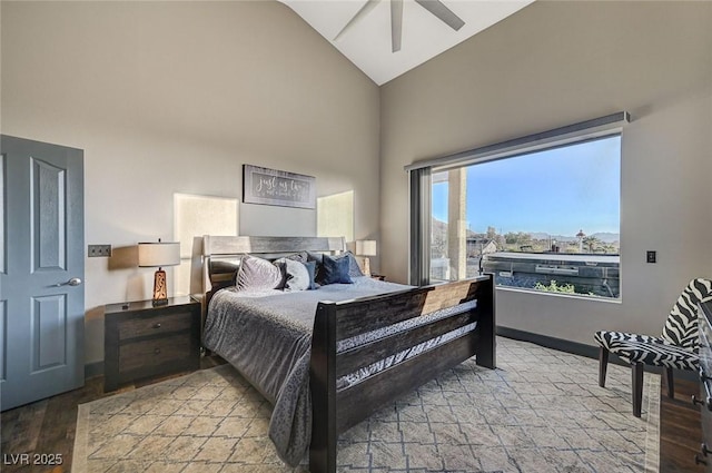 bedroom featuring ceiling fan, high vaulted ceiling, and light wood-type flooring