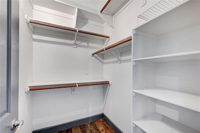 walk in closet featuring dark hardwood / wood-style flooring