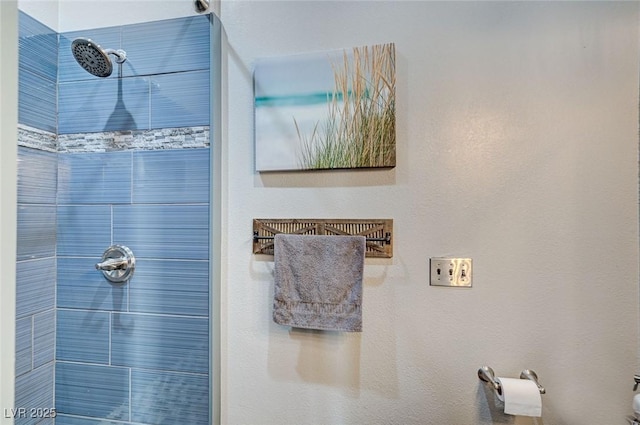 bathroom with a tile shower