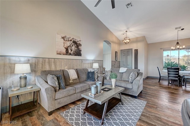 living room featuring high vaulted ceiling, dark hardwood / wood-style floors, and ceiling fan with notable chandelier