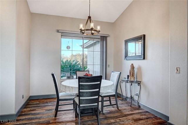 dining space featuring an inviting chandelier and dark hardwood / wood-style floors