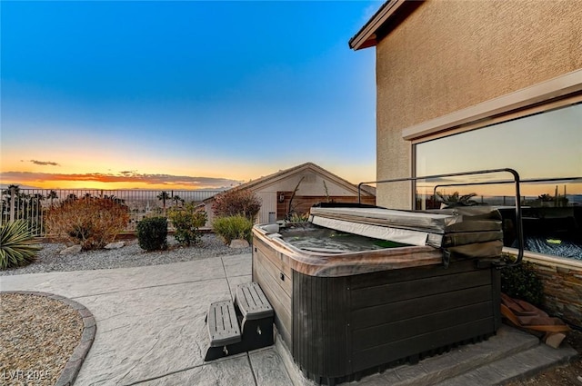 patio terrace at dusk with a hot tub