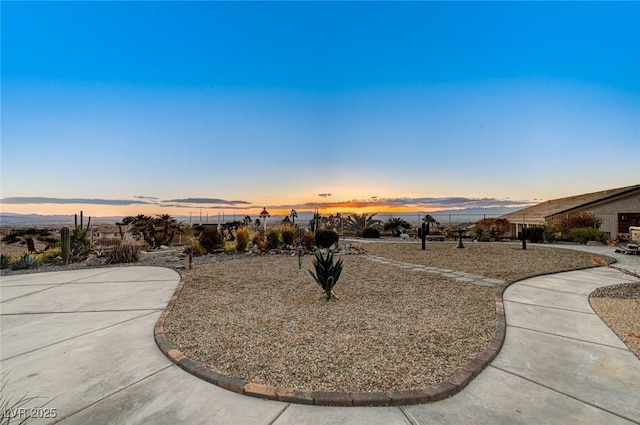 yard at dusk with a patio