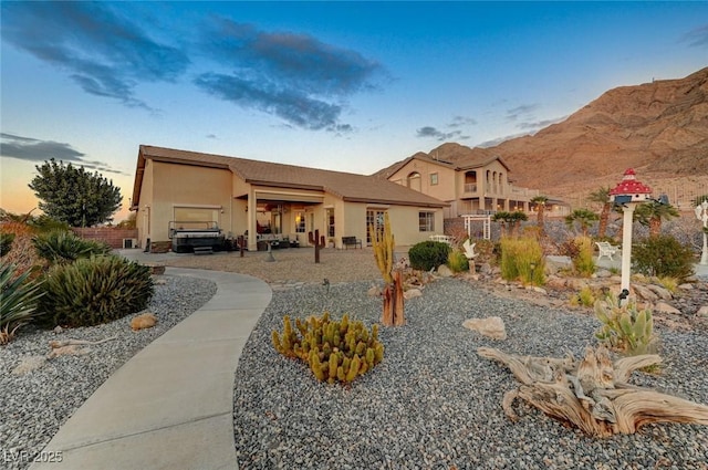 view of front facade with a garage and a mountain view