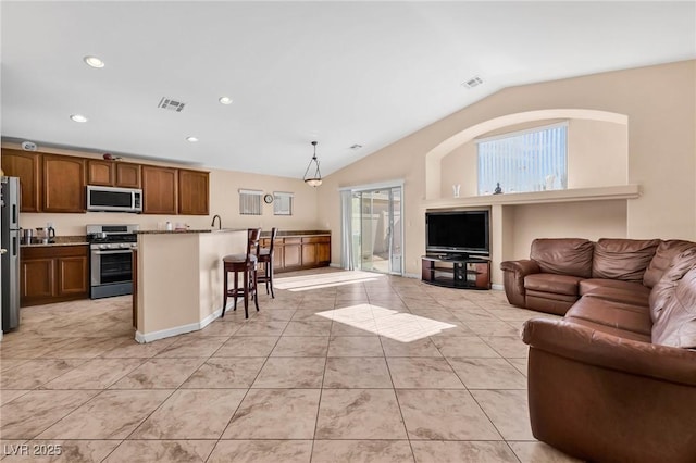 living room featuring vaulted ceiling and light tile patterned floors