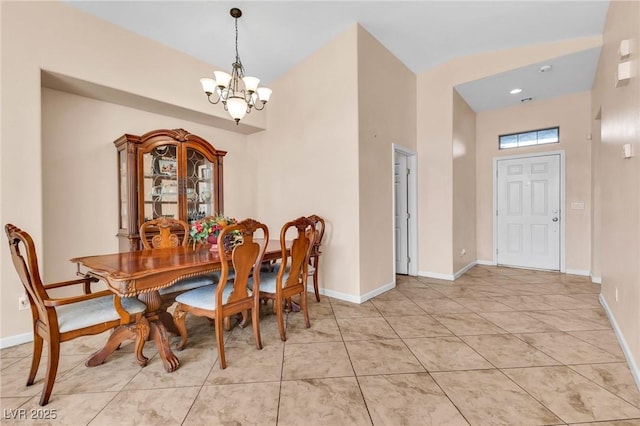 dining room featuring light tile patterned floors and a notable chandelier