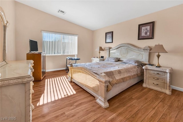 bedroom with light hardwood / wood-style flooring and vaulted ceiling