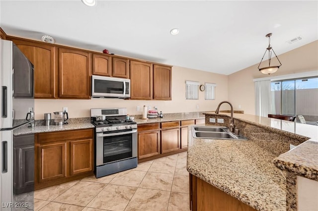 kitchen with sink, hanging light fixtures, stainless steel appliances, light stone counters, and light tile patterned flooring