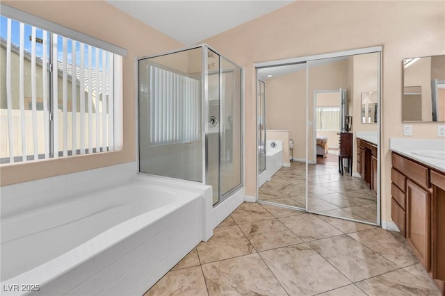 bathroom featuring vanity, separate shower and tub, and tile patterned floors