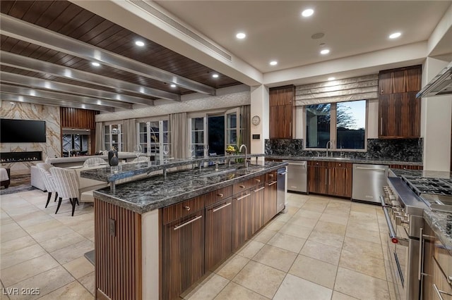 kitchen with recessed lighting, stainless steel appliances, decorative backsplash, beamed ceiling, and open floor plan