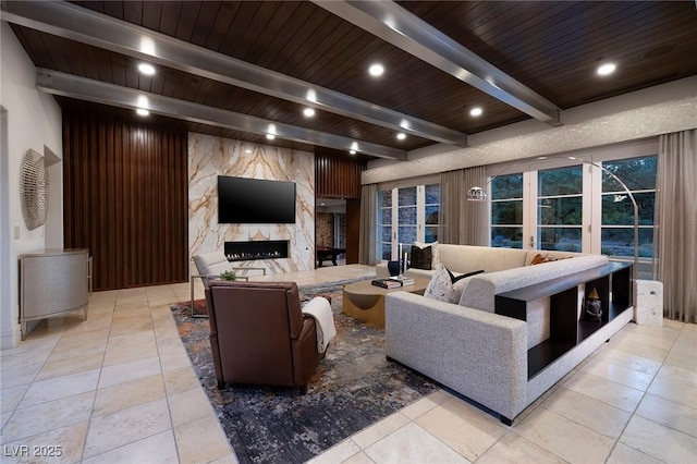 living area with a high end fireplace, beamed ceiling, recessed lighting, and wood ceiling