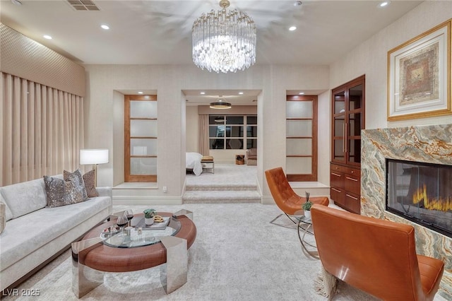 living room with a high end fireplace, recessed lighting, built in shelves, and carpet