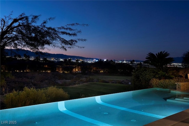 pool at dusk with a mountain view