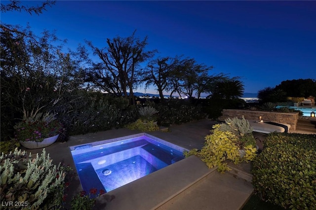 view of swimming pool featuring an in ground hot tub and a patio