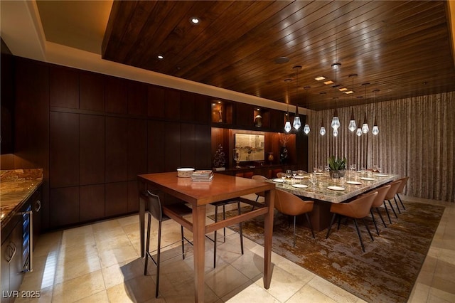 dining area with wooden walls and wood ceiling