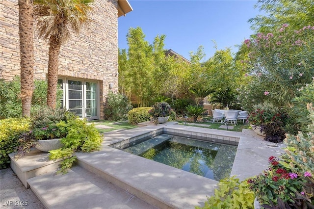 view of swimming pool with a patio and an in ground hot tub